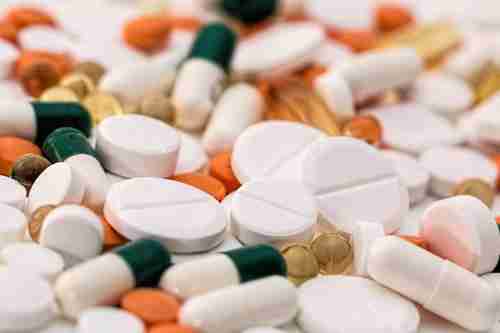 Prescription pills and supplement capsules highlighting safe administration