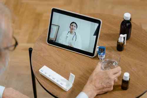 Senior patient engaging in a telehealth video consultation with their primary care physician on a digital tablet